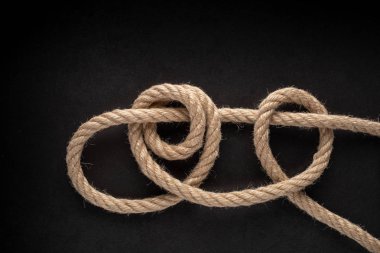 Taut-Line Hitch Knot on black background. Rope node.