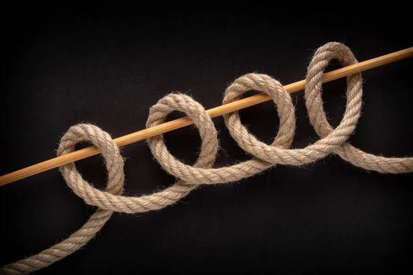 Chain Hitch Knot isolated on black background. Rope node