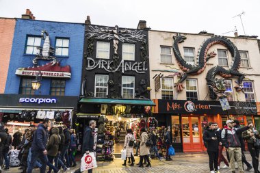 London, England UK  - December 31, 2017: People walking down the fashion shops of Camden High Street in Camden Lock or Camden Town in London, England, United Kingdom clipart