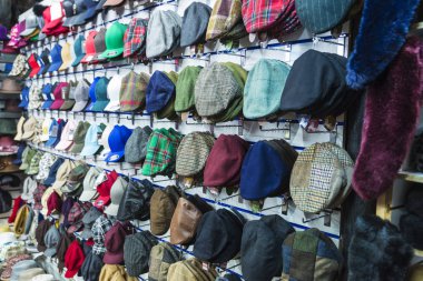 London, United Kingdom - December 31, 2017: Display of a millinery shop with hats, berets and caps in Camden Lock Market or Camden Town in London, England, United Kingdom clipart
