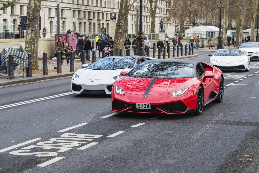 London, United Kingdom - January 1, 2017: Parade of Lamborghini Aventador on a street with people around in London, England, United Kingdom