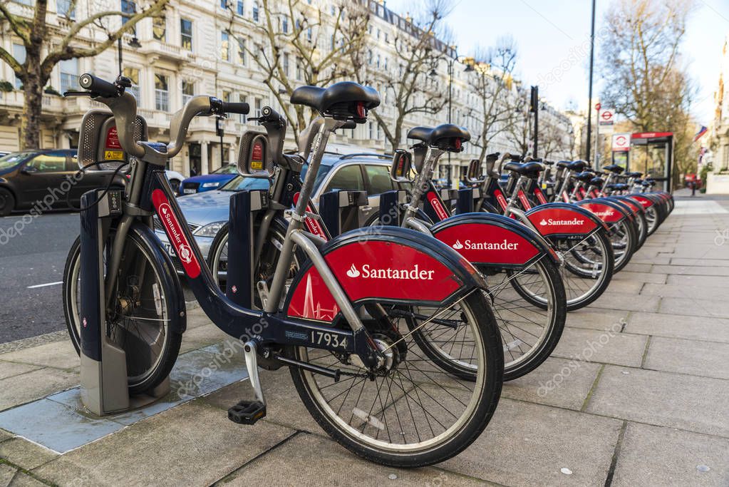 London, United Kingdom - January 3, 2018:  A row of rental bikes with advertising from Santander bank in their docking stands in London, England, United Kingdom