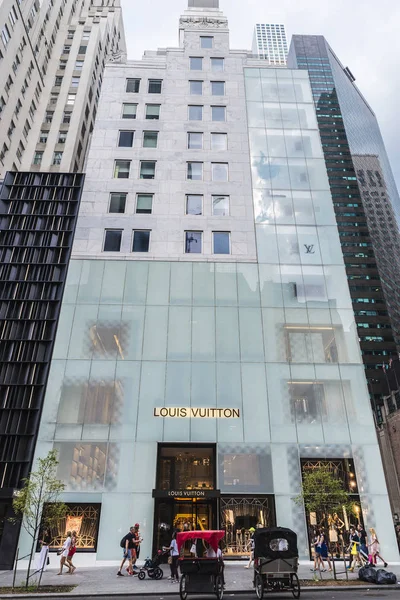 New York City, USA - July 28, 2018: Louis Vuitton, luxury clothing store, in Fifth Avenue (5th Avenue) with people around in Manhattan in New York City, USA