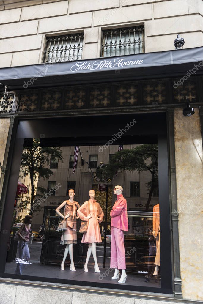 New York City, USA - July 28, 2018: Saks, luxury clothing store, in Fifth Avenue (5th Avenue) with people around in Manhattan in New York City, USA