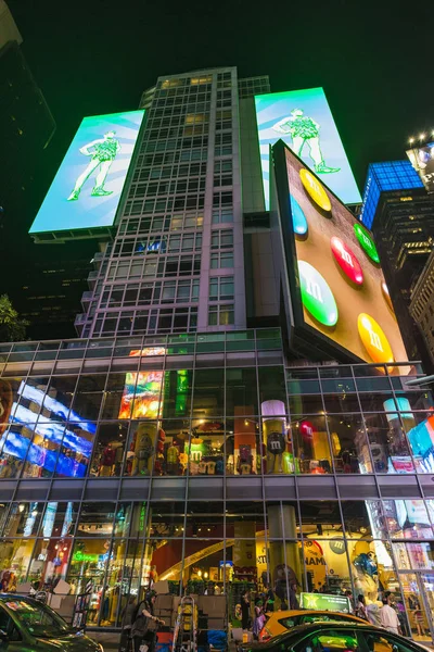 ニューヨーク アメリカ合衆国 2018 のショップ そのカラフルなボタンの形をしたチョコレート夜 マンハッタン タイムズ スクエアの隣に周りの人々 とアメリカ ニューヨーク市のマンハッタンの大規模な広告画面で有名です — ストック写真
