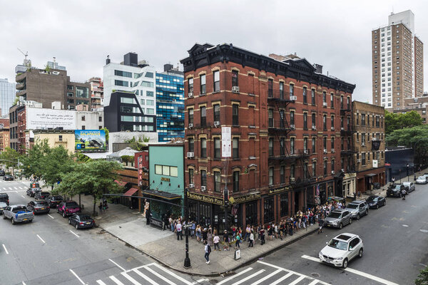 New York City, USA - July 25, 2018: People in a row on a street in Manhattan in New York City, USA