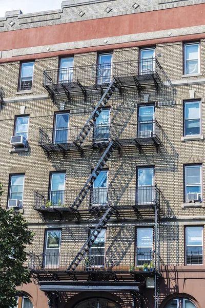 Old typical houses with its emergency stairs in the Brooklyn neighborhood in Manhattan, New York City, USA