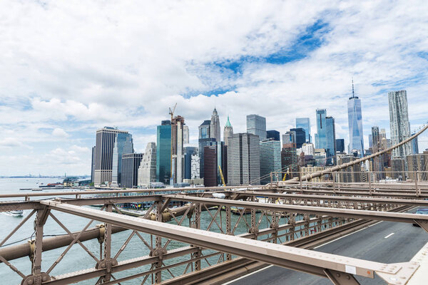 View of Manhattan skyscrapers from the Brooklyn Bridge in New York City, USA