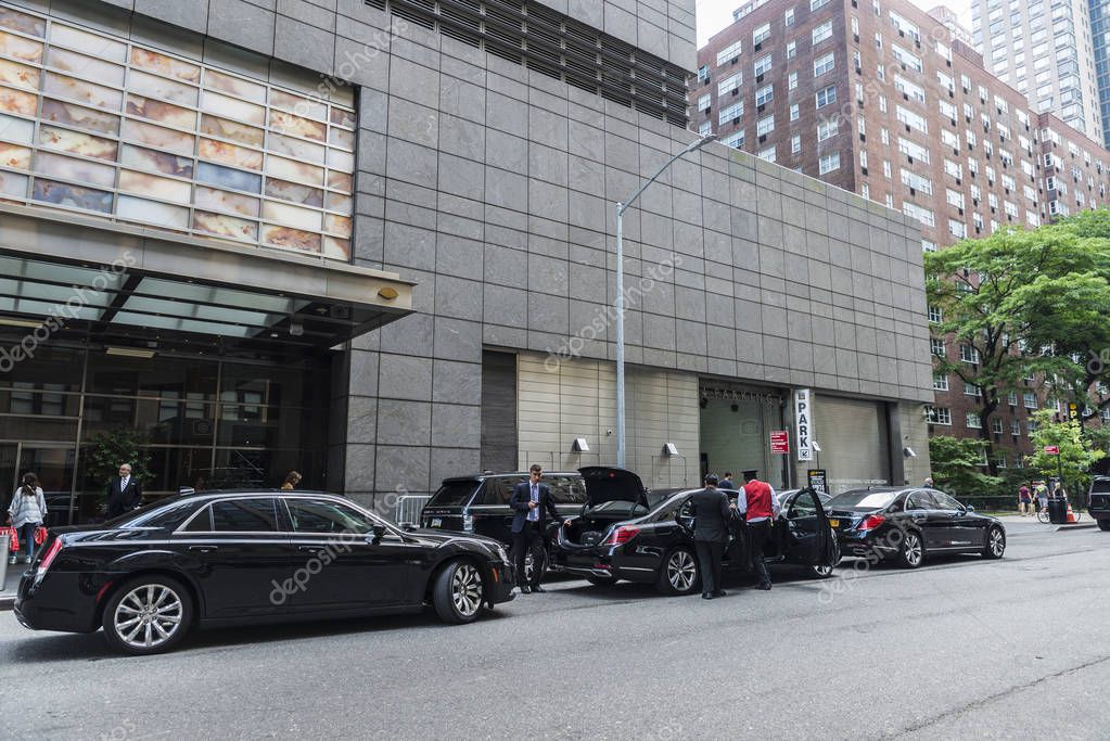New York City, USA - July 28, 2018: Facade of the Mandarin Oriental New York Hotel with black luxury cars and people around in Manhattan, New York City, USA