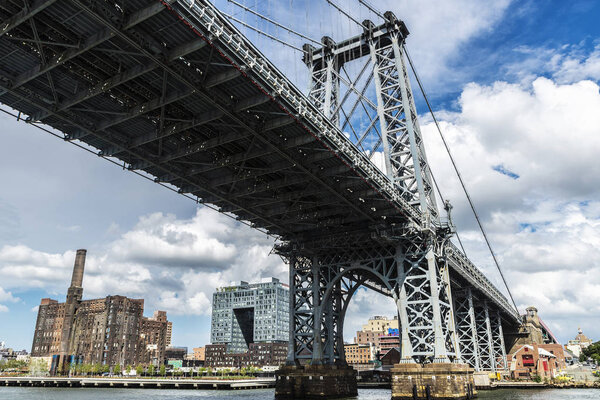 View of the Williamsburg Bridge seen from East River in New York City, USA