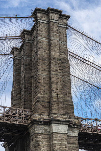 Column of the Brooklyn Bridge seen from East River in New York City, USA
