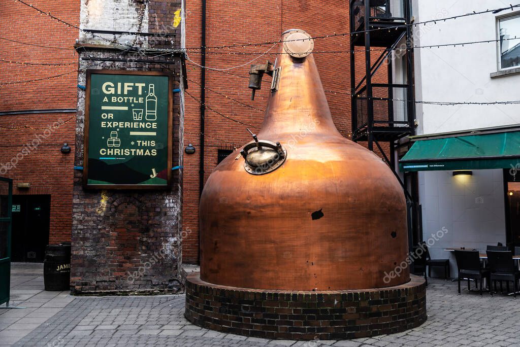 Dublin, Ireland - December 30, 2019: Large copper alembic in the Jameson Distillery in Bow Street and Smithfield Square, Dublin, Ireland