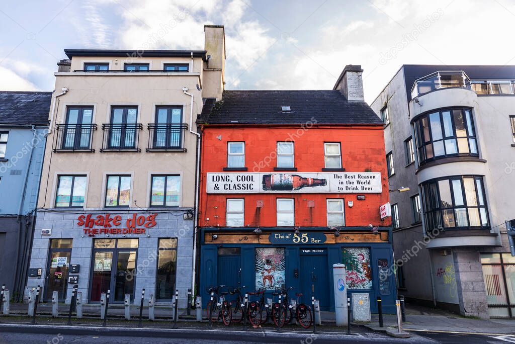 Galway, Ireland - January 3, 2020: Street with shop and an irish pub in the center of Galway, Ireland
