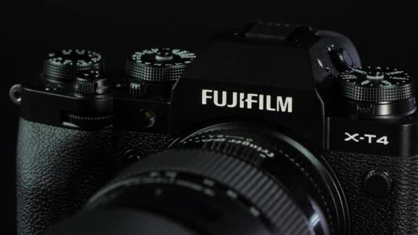 TOMSK, RUSSIA - May 28, 2020: FUJIFILM X-T4 body with Fringer ef-fx proII adapter and sigma 18-35 standing on a black rotation stand, black background — 비디오