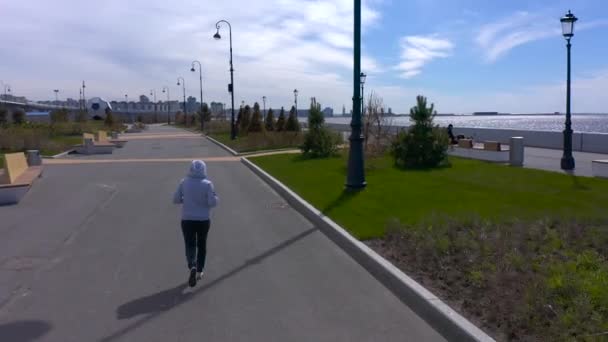 聖ペテルスブルグ ロシア 5月22 2020 灰色のセーターの女の子が遊歩道に沿って走っています 街を飛行中 — ストック動画
