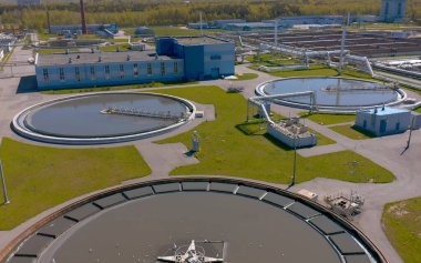 Aerial view of the wastewater treatment plant. Round sedimentation tanks. Radial primary pallet. Sediments of treatment facilities. clipart