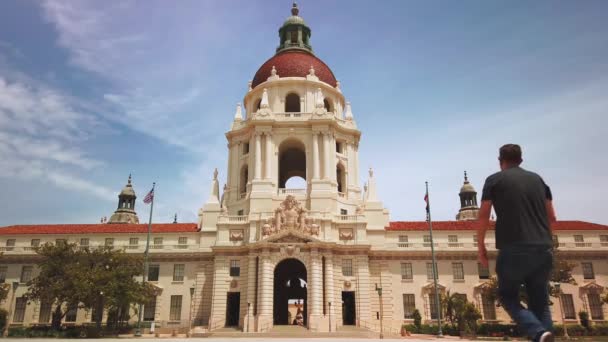 Man loopt richting Pasadena City Hall Building, Mediterraans Spaans gebouw — Stockvideo
