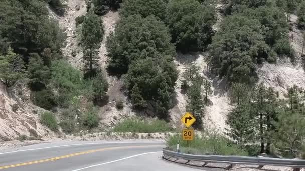 Car on Road Under Hills of Big Bear Mountain, California USA Royalty Free Stock Video
