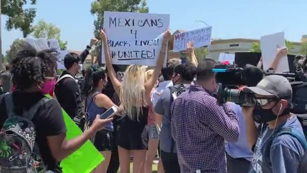 Demonstranter med skilt, meksikanere for svarte liv, forente, fredelige Los Angeles – stockvideo