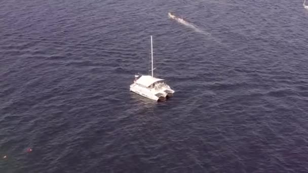 Catamaran boat sailing off Pacific coast of Cabo Baja California, aerial view Royalty Free Stock Footage