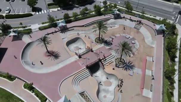 Aerial orbit view, skate park of young kids riding bikes and skateboards Video Clip