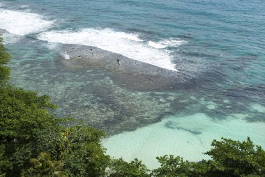 The aerial view of shallow transparent waters in Ocho Rios resort town (Jamaica).
