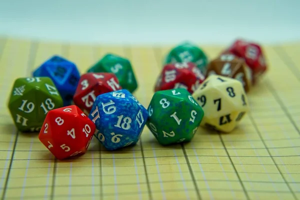 Yellow role-playing board with several colored dice on top in a pentagonal shape