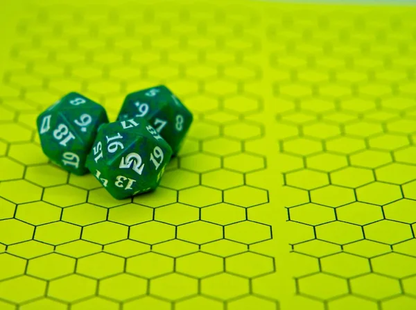 Role-playing board with three green dice on top in a pentagonal shape