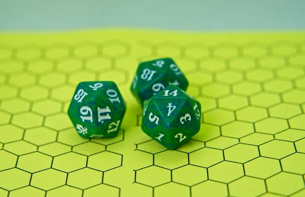 Role-playing board with three green dice on top in a pentagonal shape