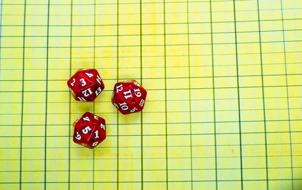 Yellow role-playing board with three red dices on top