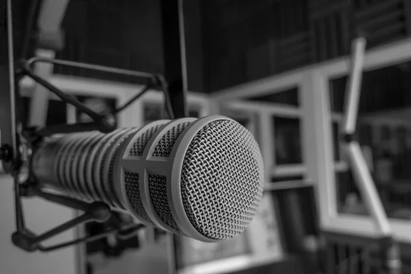 Professional microphone in radio station studio and on air sign