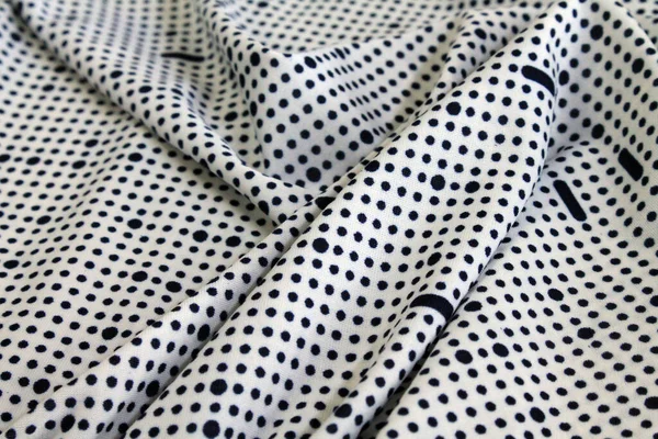 Motley kumaş. Beyaz arkaplanda noktalar.