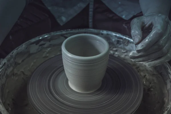 Creating ceramic products of white clay close-up.