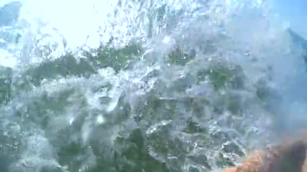 Girl makes her hands with strong splashes of spray — Stock Video