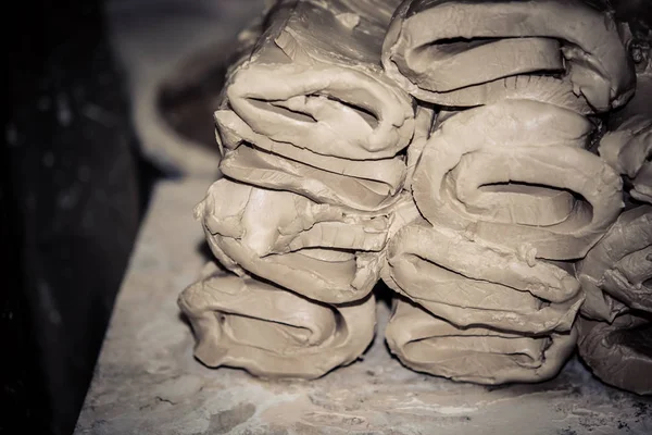 Wet white clay closeup. Abstract pieces of wet clay on the table