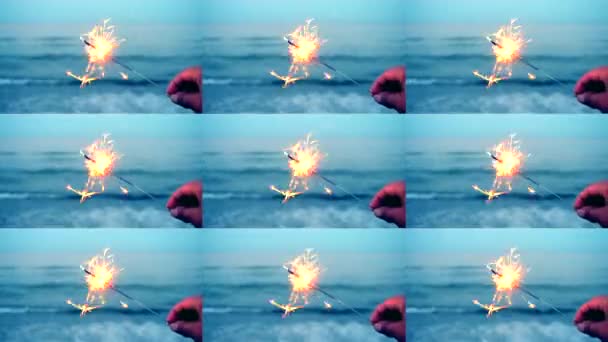 Burning one Bengal fire in hand against the background of a sea ocean wave — Stock Video