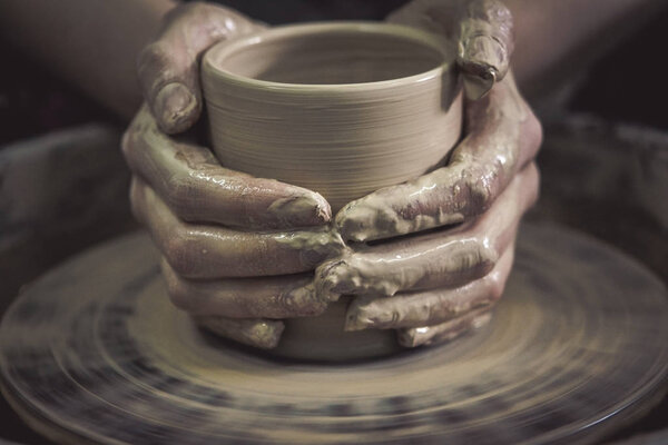 Creating ceramic products of white clay close-up.