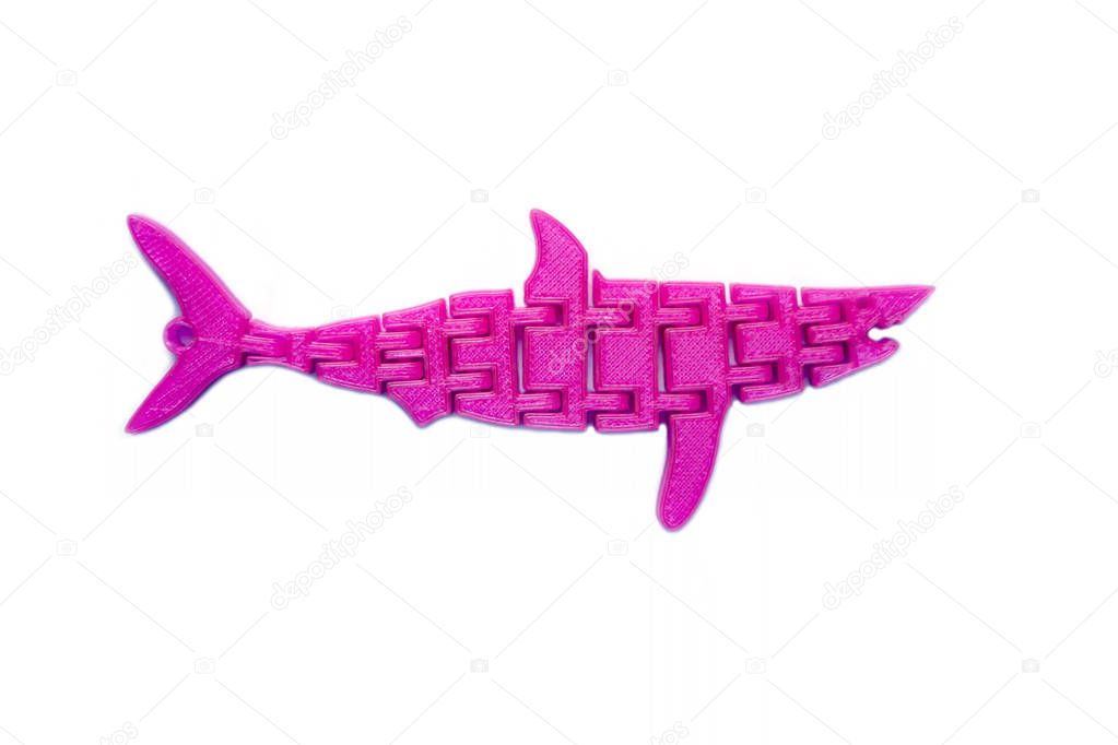 Bright light pink object in shape of fish toy printed on 3d printer