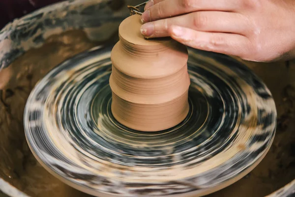 Creating ceramic products of white clay close-up.