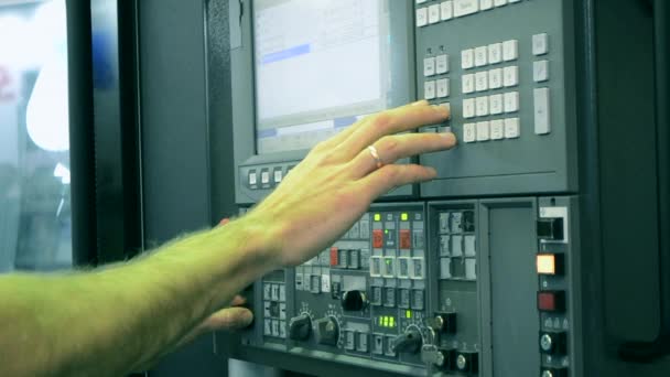 El hombre que trabaja en el panel de control trabaja con una máquina industrial en la fábrica — Vídeo de stock