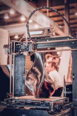 3D yazıcı siyah vazo gibi yakın plan bir model yazdırıyor.