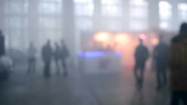 Muitas pessoas caminham em um quarto cheio de fumaça — Vídeo de Stock