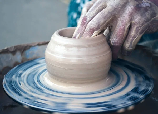 Creating vase of white clay close-up.