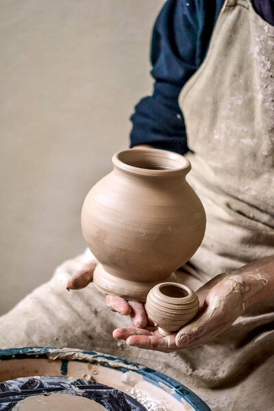 Potter holds made pots