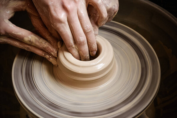 Creating vase of white clay close-up. Master crock.