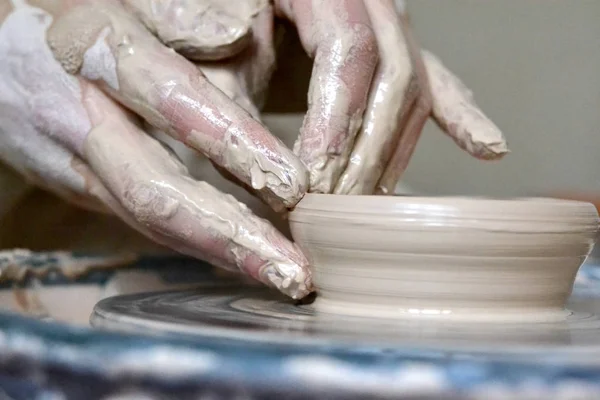 soiled hands in the clay and clay plate