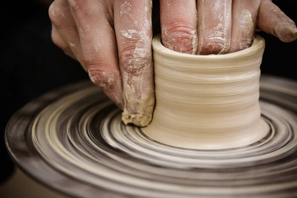 Creating vase of white clay close-up. Master crock.