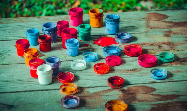 Paint jars on a wooden surface — Stock Photo, Image