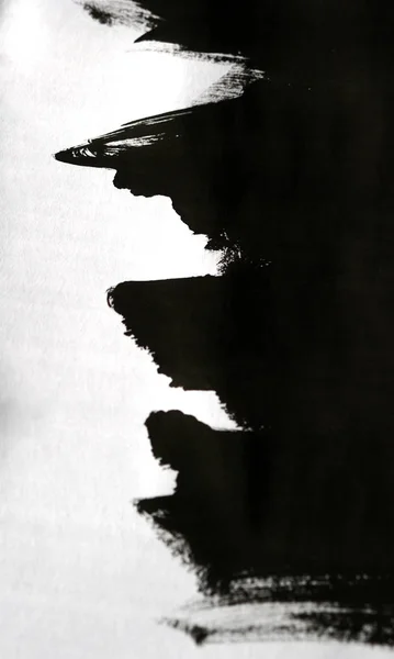 Pinceladas negras sobre papel blanco con una mano aislada —  Fotos de Stock