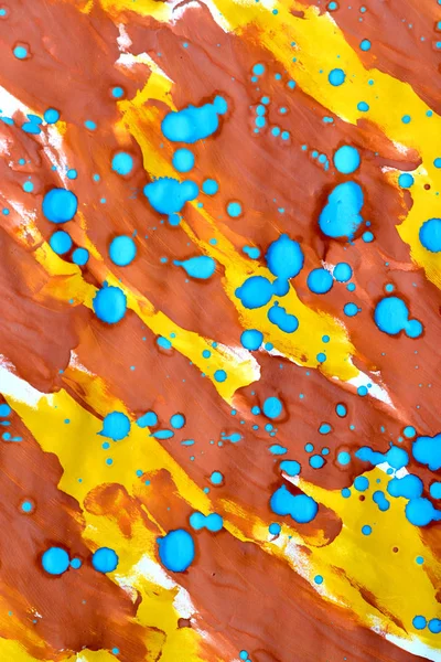 abstract background yellow brown strokes of paint and blue drops